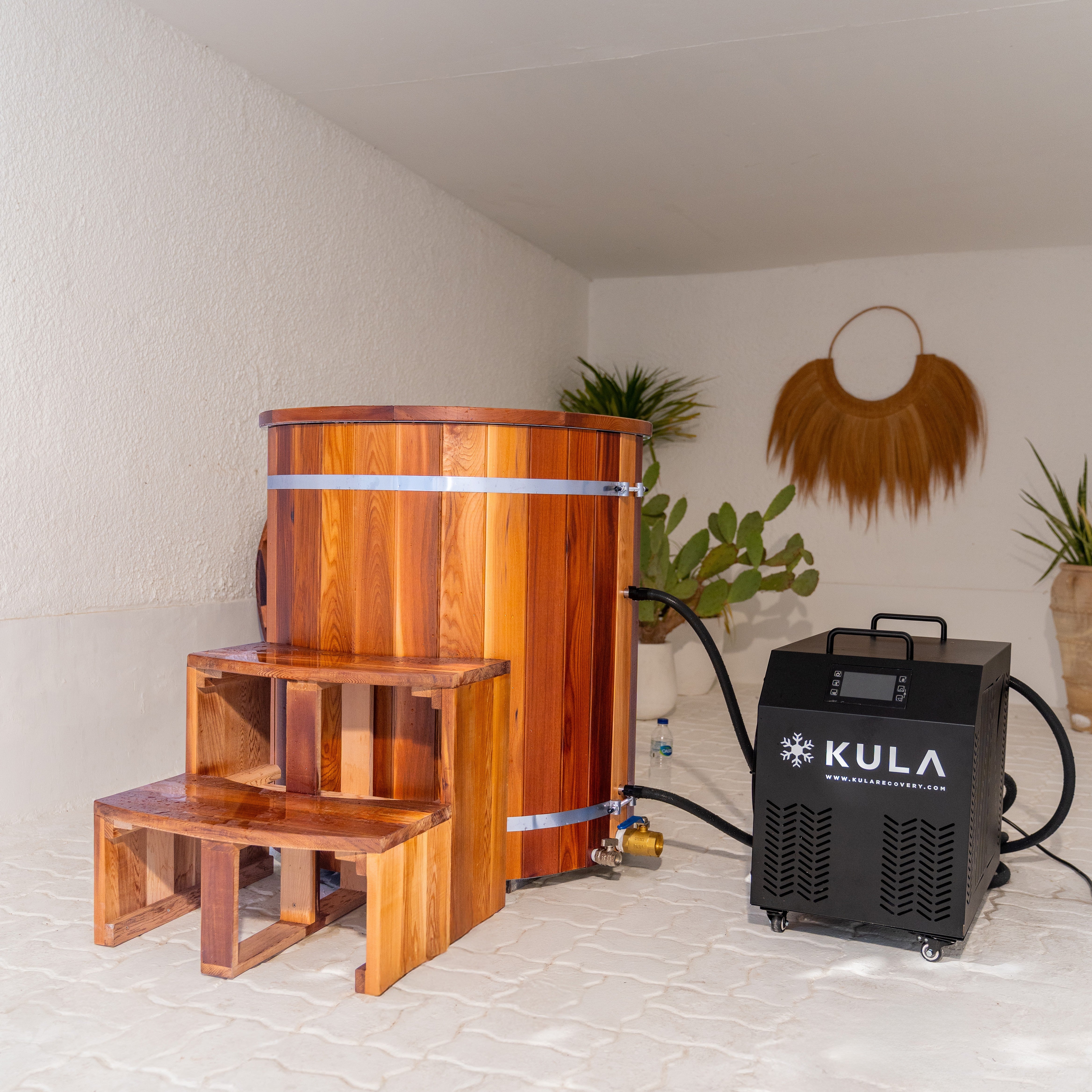 Woman enjoying cold water therapy in KULA Shogun barrel plunge
