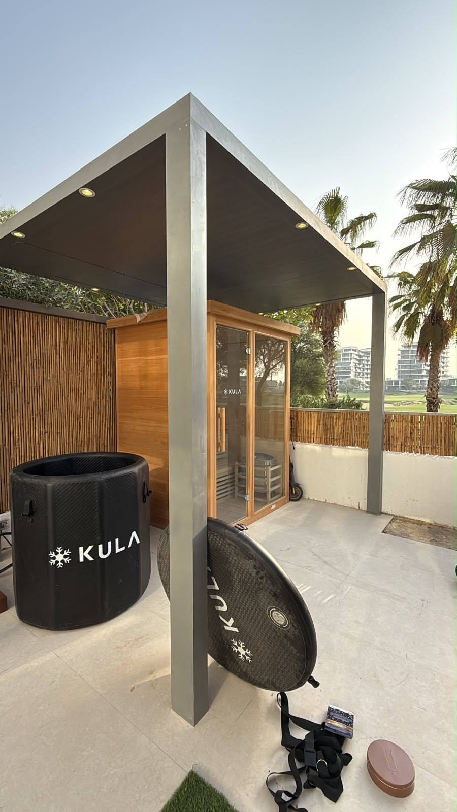 KULA inflatable ice bath and outdoor sauna under a pergola on a Dubai villa terrace