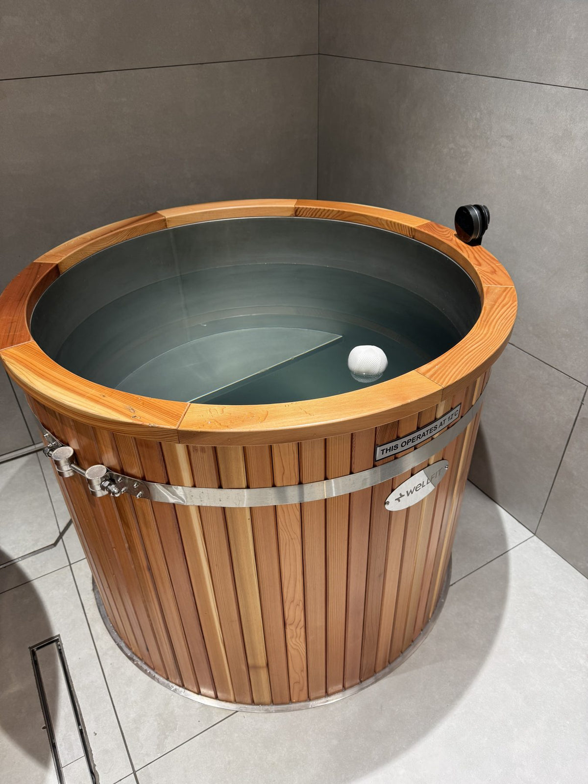 Close-up of a KULA red cedar barrel cold plunge at Wellfit JVC, Dubai